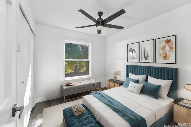 bedroom featuring ceiling fan, a closet, baseboards, and wood finished floors