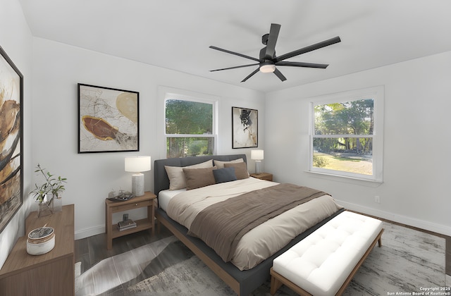 bedroom featuring multiple windows, a ceiling fan, baseboards, and wood finished floors