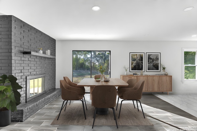 dining space featuring recessed lighting, a brick fireplace, and baseboards