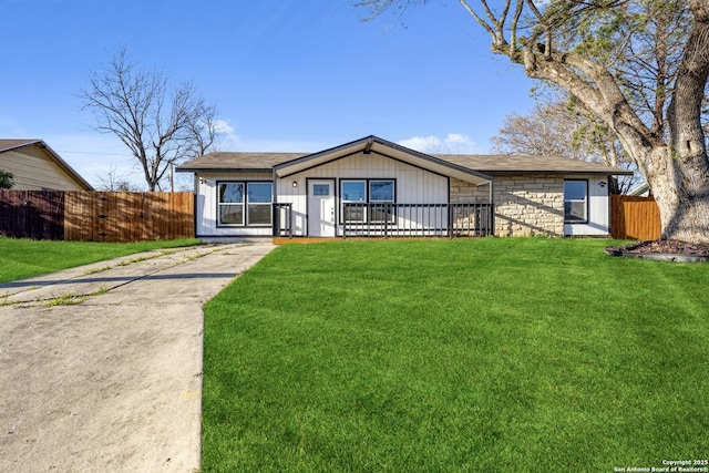 view of front of property with a front yard and fence