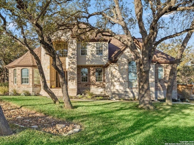 view of front of property with brick siding and a front lawn