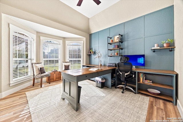 home office featuring baseboards, wood finished floors, and a ceiling fan