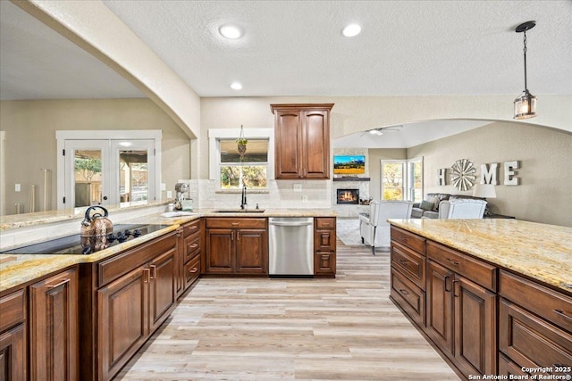 kitchen with backsplash, dishwasher, light wood-type flooring, french doors, and a sink