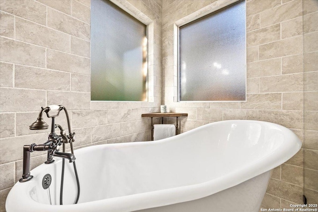 bathroom featuring a soaking tub