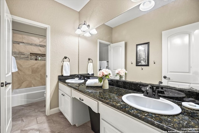 full bathroom featuring double vanity, shower / washtub combination, and a sink