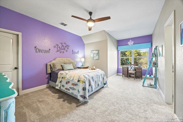 bedroom with carpet, visible vents, and a textured wall