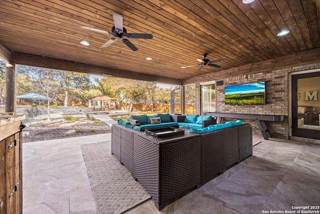 view of patio with outdoor lounge area and a ceiling fan