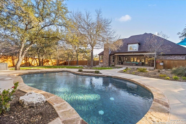 view of swimming pool with a patio, a fenced backyard, a fenced in pool, and an outdoor living space