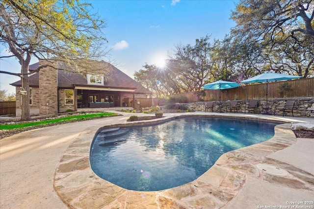 view of swimming pool with a fenced in pool, a patio, and a fenced backyard