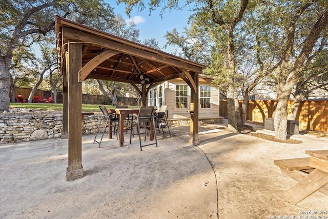 view of patio / terrace featuring a gazebo, outdoor dining area, and fence private yard