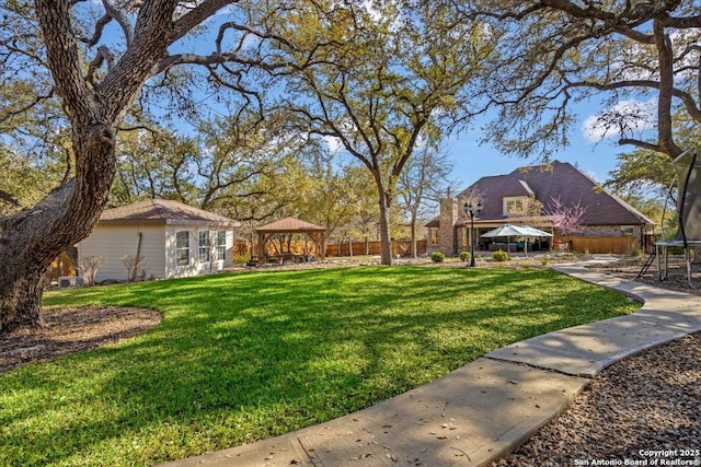 view of yard featuring a gazebo and a trampoline