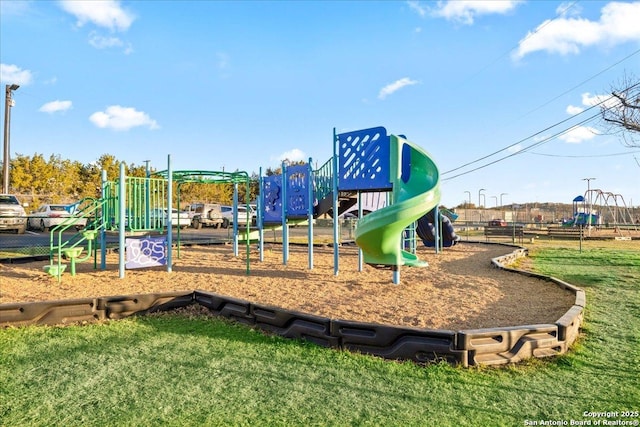 communal playground featuring a yard