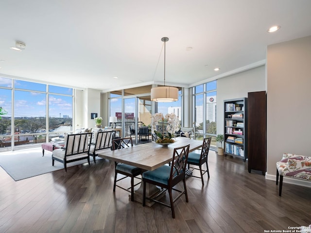 dining space featuring dark wood finished floors, recessed lighting, baseboards, and expansive windows