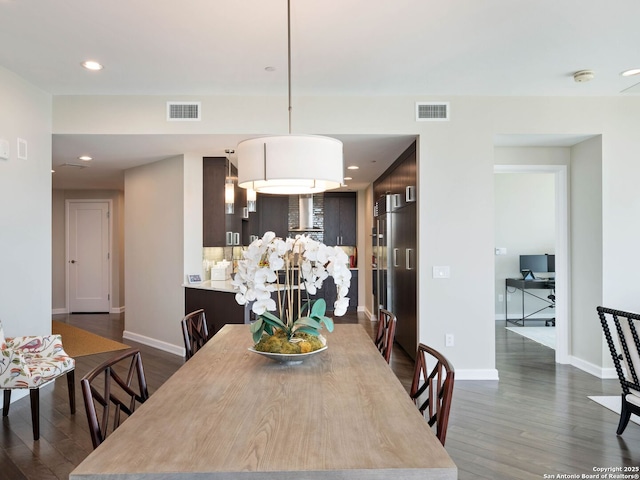 dining room featuring visible vents, baseboards, and dark wood-style flooring