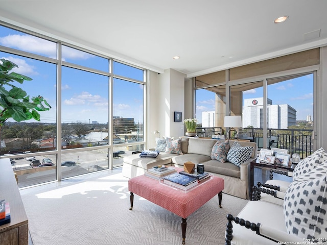 living area featuring a wall of windows, a view of city, and recessed lighting