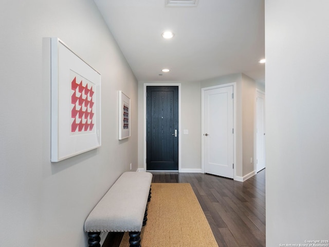 foyer with recessed lighting, baseboards, and dark wood-style flooring