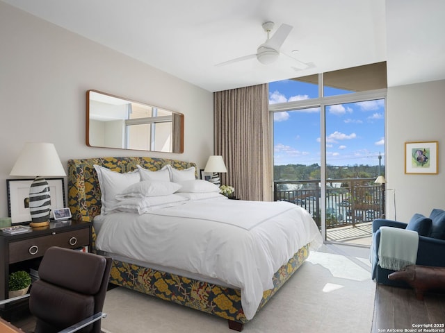 bedroom with a wall of windows, access to outside, and a ceiling fan