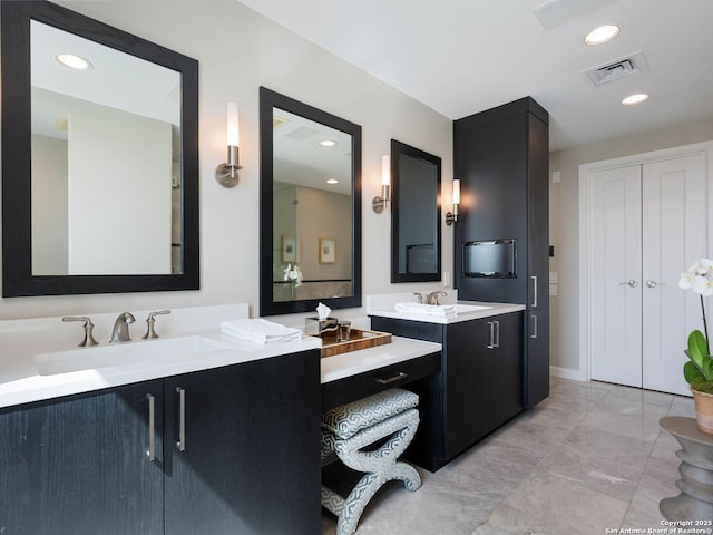 bathroom with recessed lighting, visible vents, and vanity