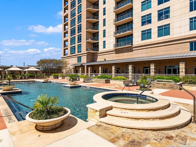 community pool featuring a patio area and fence