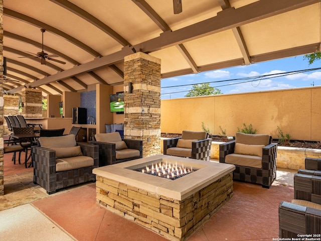 view of patio / terrace with an outdoor living space with a fire pit and ceiling fan