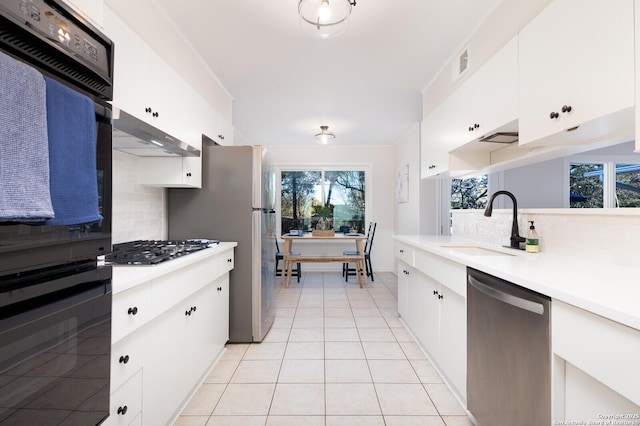 kitchen with visible vents, appliances with stainless steel finishes, light countertops, and a sink