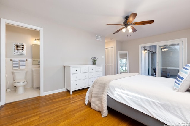 bedroom featuring light wood finished floors, visible vents, access to exterior, ensuite bathroom, and a closet