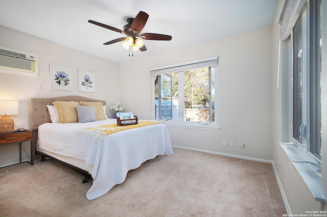 bedroom featuring baseboards, a ceiling fan, a wall unit AC, and carpet floors