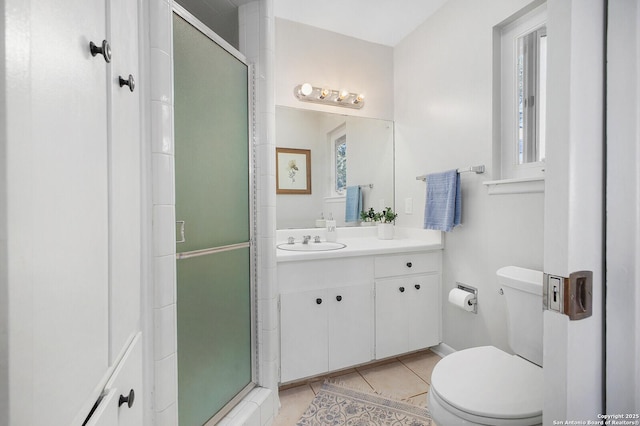 bathroom with vanity, toilet, a shower stall, and tile patterned flooring