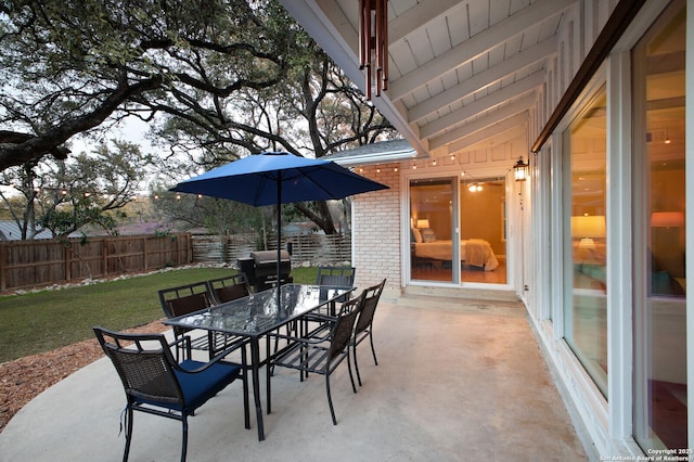 view of patio featuring outdoor dining space and fence