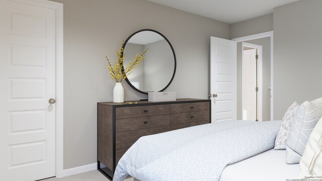 bedroom featuring light colored carpet and baseboards