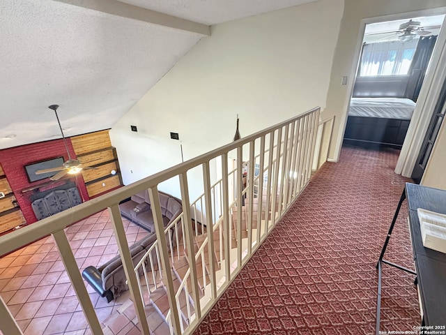 corridor featuring a textured ceiling, vaulted ceiling with beams, and carpet flooring