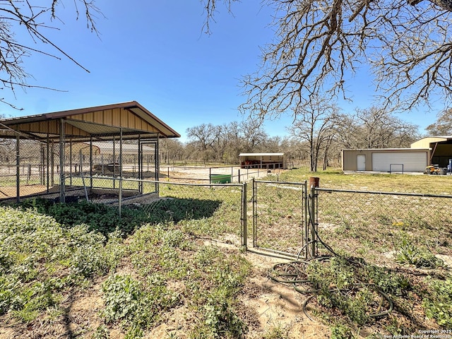 view of yard with an outbuilding and fence