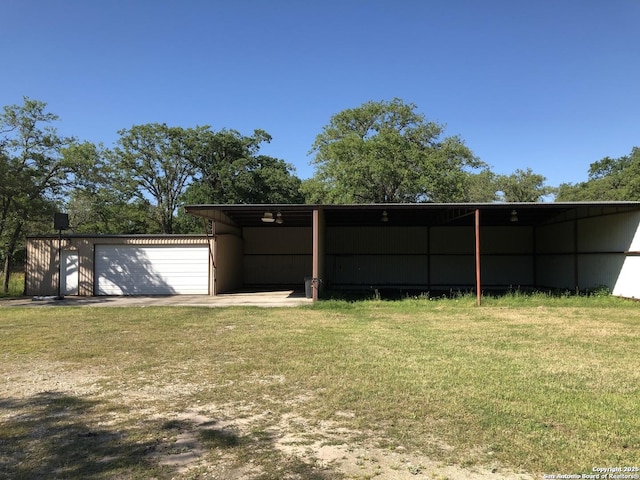 view of yard featuring an outbuilding, an outdoor structure, and a carport