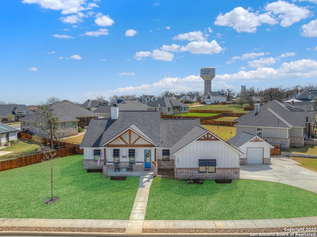 view of front of house with brick siding, a residential view, a shingled roof, and a front lawn