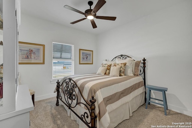 bedroom with light carpet, a ceiling fan, and baseboards