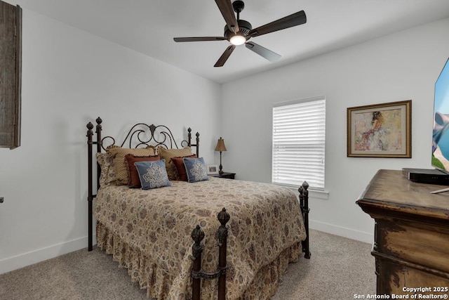 carpeted bedroom featuring baseboards and ceiling fan