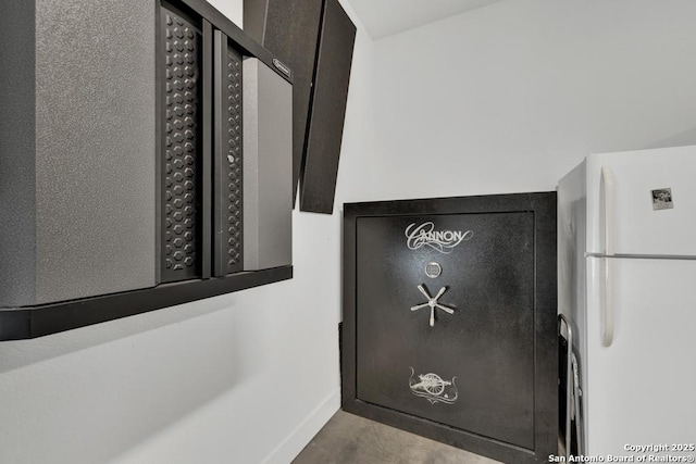 interior details with baseboards and freestanding refrigerator