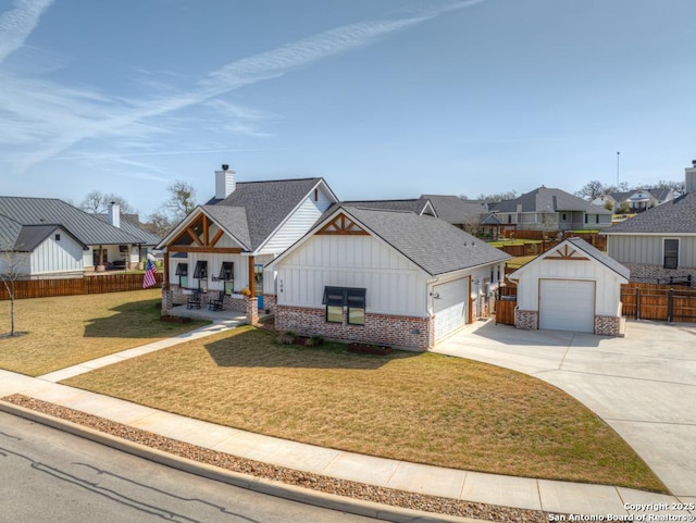 view of front of home featuring a front yard, fence, covered porch, a residential view, and board and batten siding