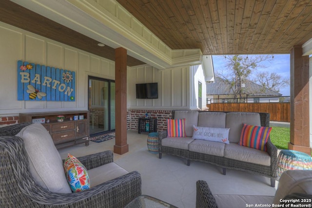 view of patio featuring an outdoor living space and fence