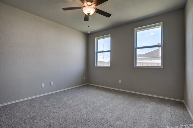 unfurnished room featuring baseboards, a ceiling fan, and carpet floors