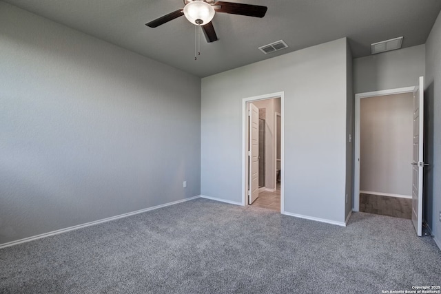 unfurnished bedroom with visible vents, carpet floors, and baseboards