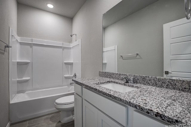 bathroom featuring vanity, shower / bathing tub combination, and toilet