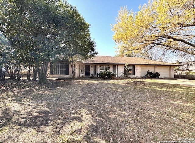 ranch-style home with brick siding and an attached garage