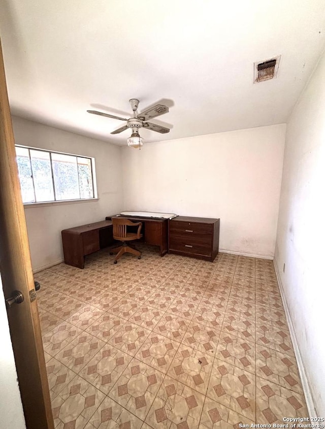 office space featuring baseboards, visible vents, built in study area, and ceiling fan