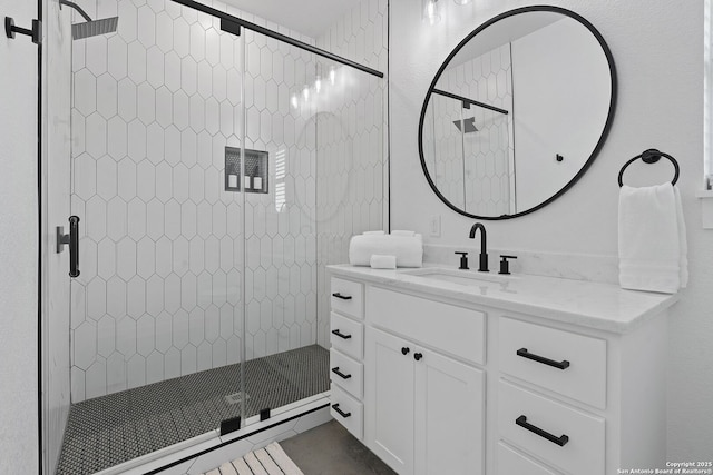 bathroom featuring a stall shower and vanity