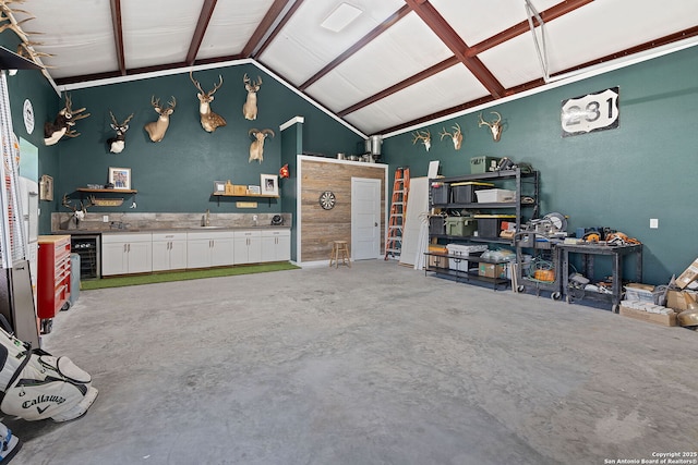 garage featuring wine cooler and a sink