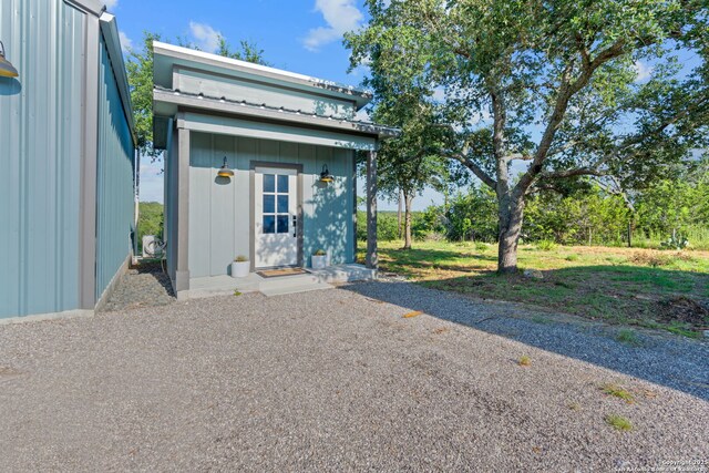 view of front of house featuring an outbuilding and metal roof