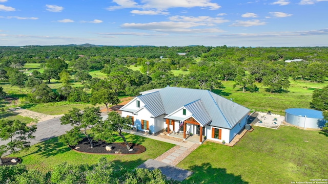 birds eye view of property featuring a wooded view