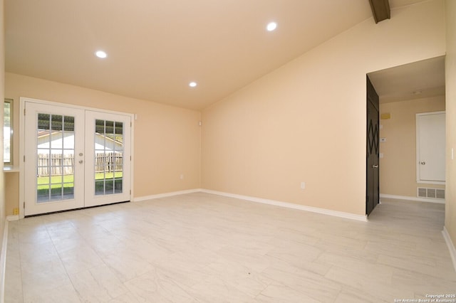 spare room featuring visible vents, french doors, baseboards, and lofted ceiling