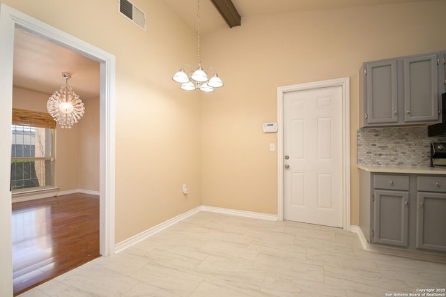 unfurnished dining area with a notable chandelier, baseboards, lofted ceiling with beams, and visible vents